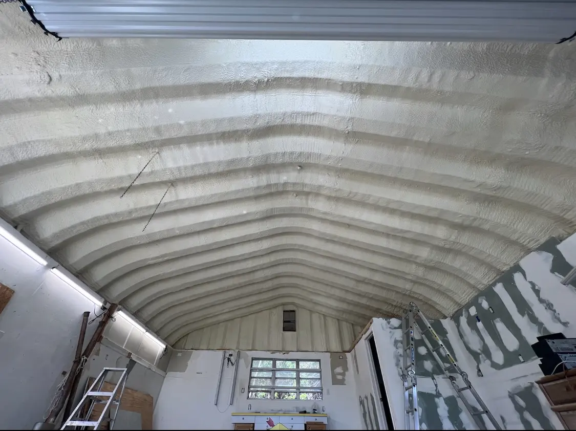 Spray polyurethane foam applied to the underside of a metal roof deck in Lugoff